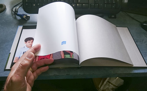 white logo page in a book with all black pages