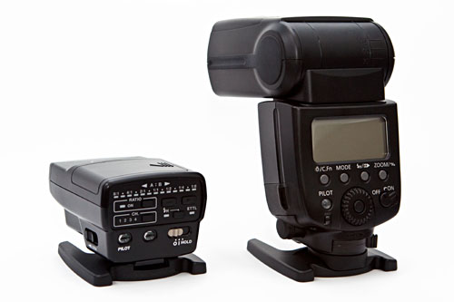 different sizes: Canon ST-E2 Wireless Flash Transmitter and Canon 580EX II Flash
