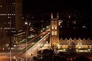 a 20 second exposure creates light trails from passing cars on the streets below on a dark night