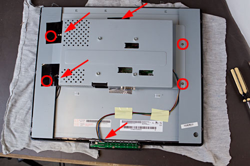 figure 5: six cables need to be disconnected (arrowed), and four screws hold the metal bracket to the screen (circled)