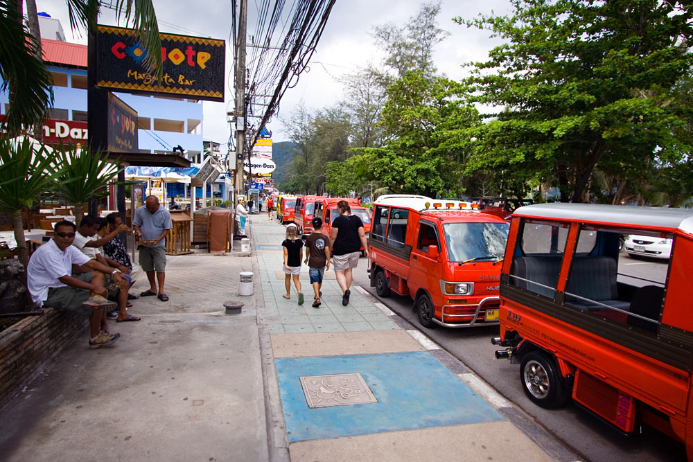 Tuk-tuks waiting on the side of the road