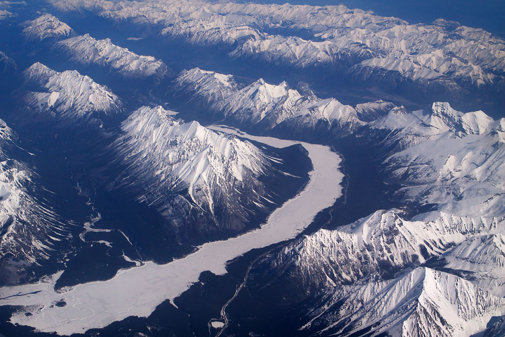 frozen river and snowy Rockies