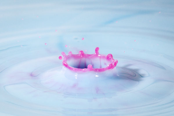 red water dropping into blue milk