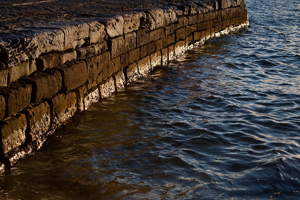setting sun lights up a rock wall