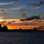 sun setting behind Sydney city