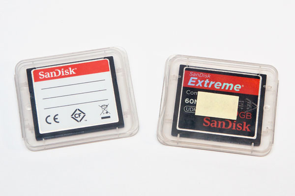 two full memory cards in their cases (front of memory cards facing TOWARDS from the label)