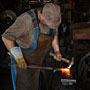 blacksmith shaping hot metal (Calgary, Canada)