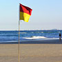 Lonely lifeguard flag on the beach